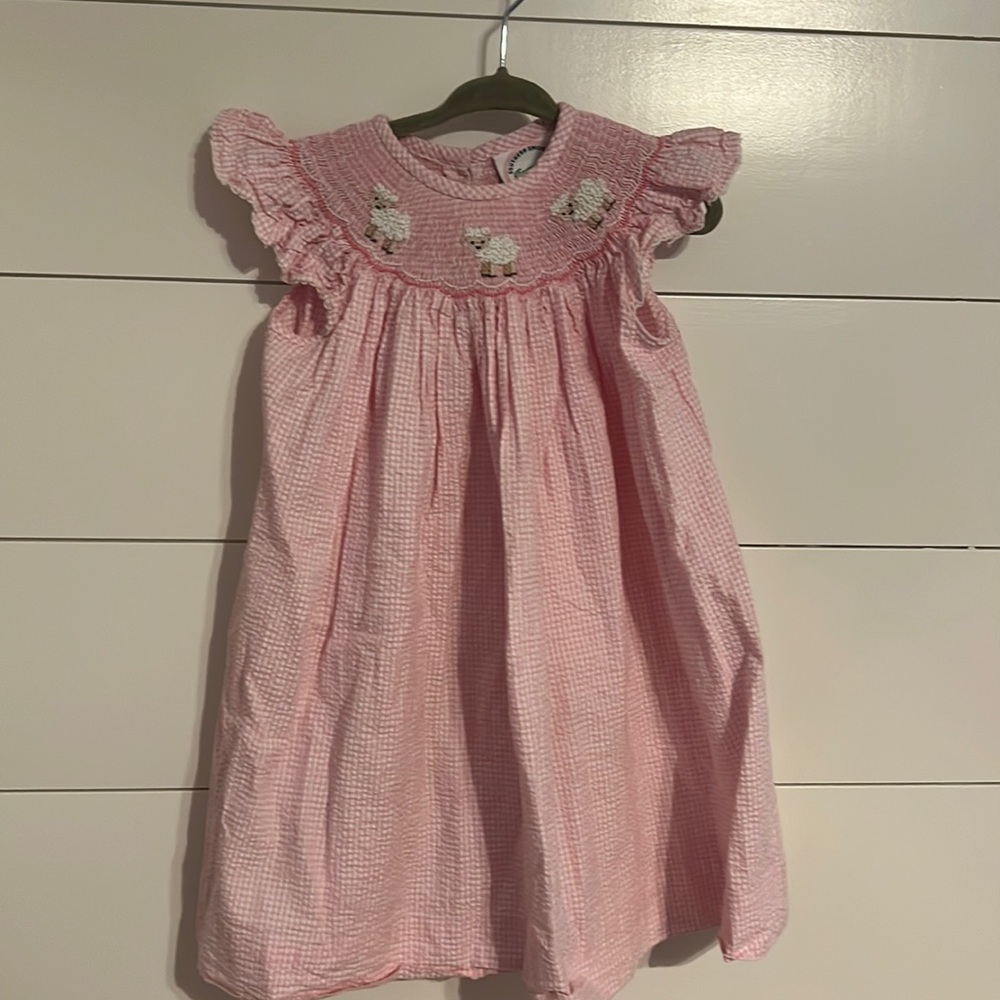 Pink gingham dress with smocking of baby lambs